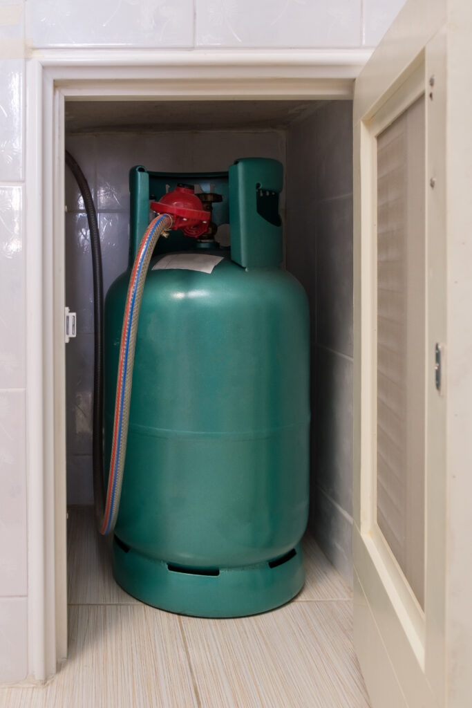 the lpg gas tank for cooking is stored in the small storage comp